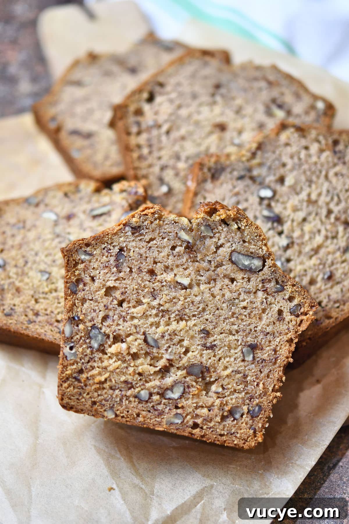 Nicely sliced dairy free banana bread with no eggs  on a parchment paper.