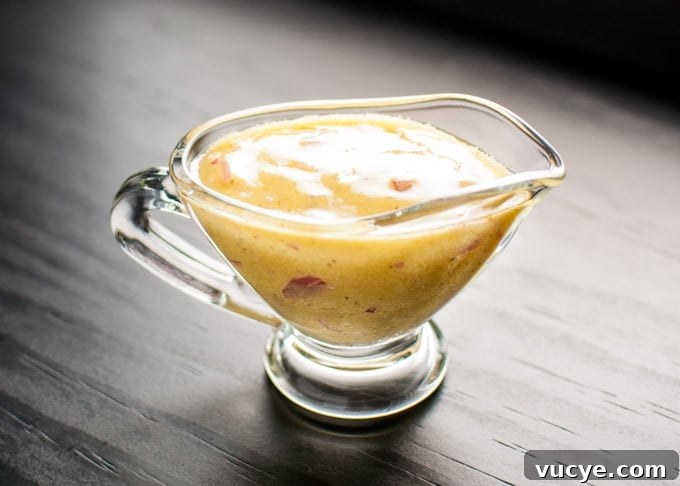 a small glass serving bowl of garlic, rice vinegar, Dijon mustard, and olive oil vinaigrette