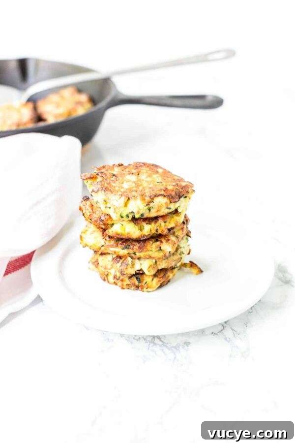 These zucchini feta fritters are quick and easy to make. A great appetizer or snack and really light. Crispy zucchini fritters contain the whole zucchini and are freezer friendly.