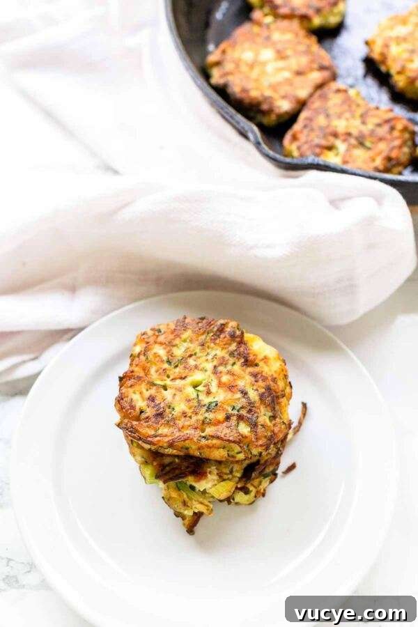 These zucchini feta fritters are quick and easy to make. A great appetizer or snack and really light. Crispy zucchini fritters contain the whole zucchini and are freezer friendly.