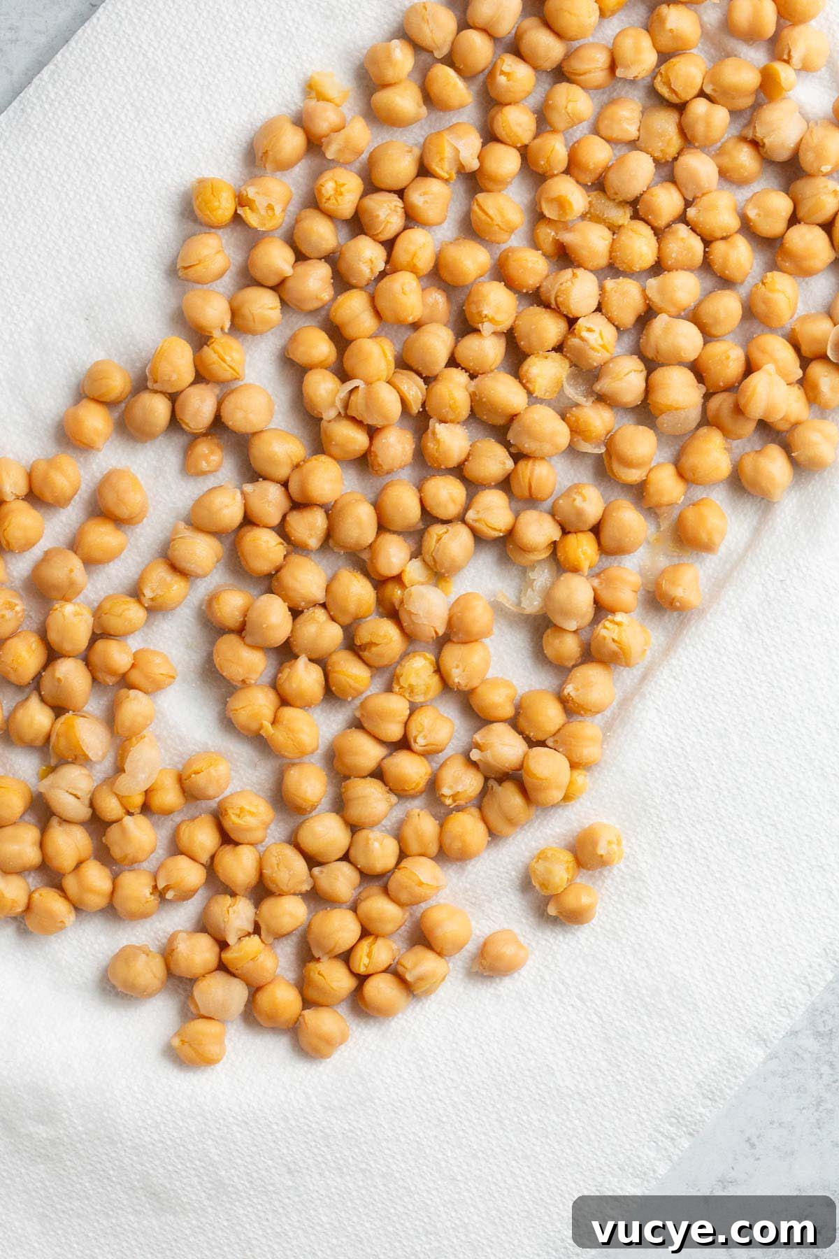 Crispy Oil-Free Air Fryer Chickpeas for Snacking 3 Chickpeas drying on a paper towel