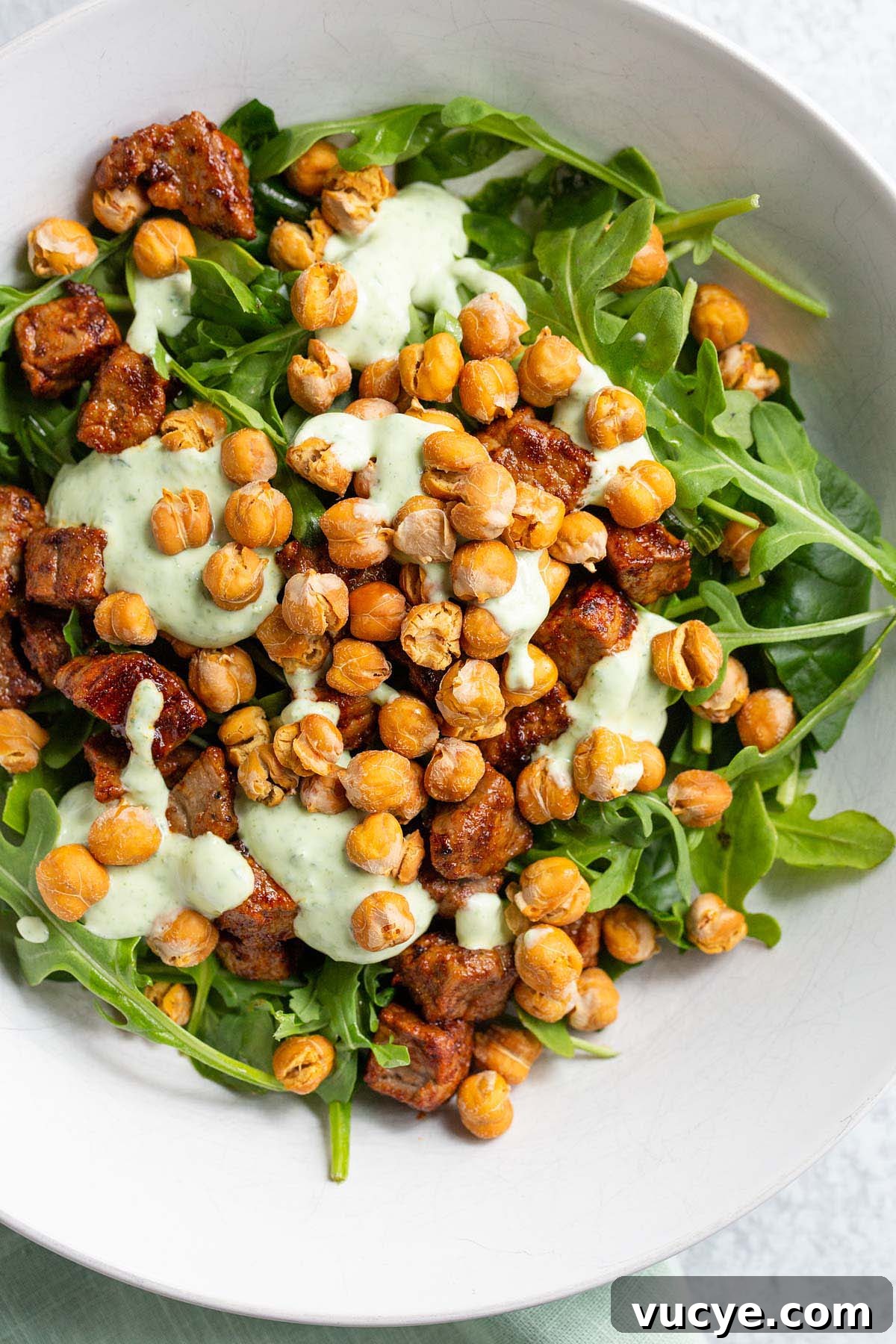Crispy Oil-Free Air Fryer Chickpeas for Snacking 7 Air fried chickpeas on top of a salad