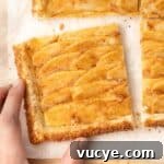 A hand picking up one slice from a cutting board