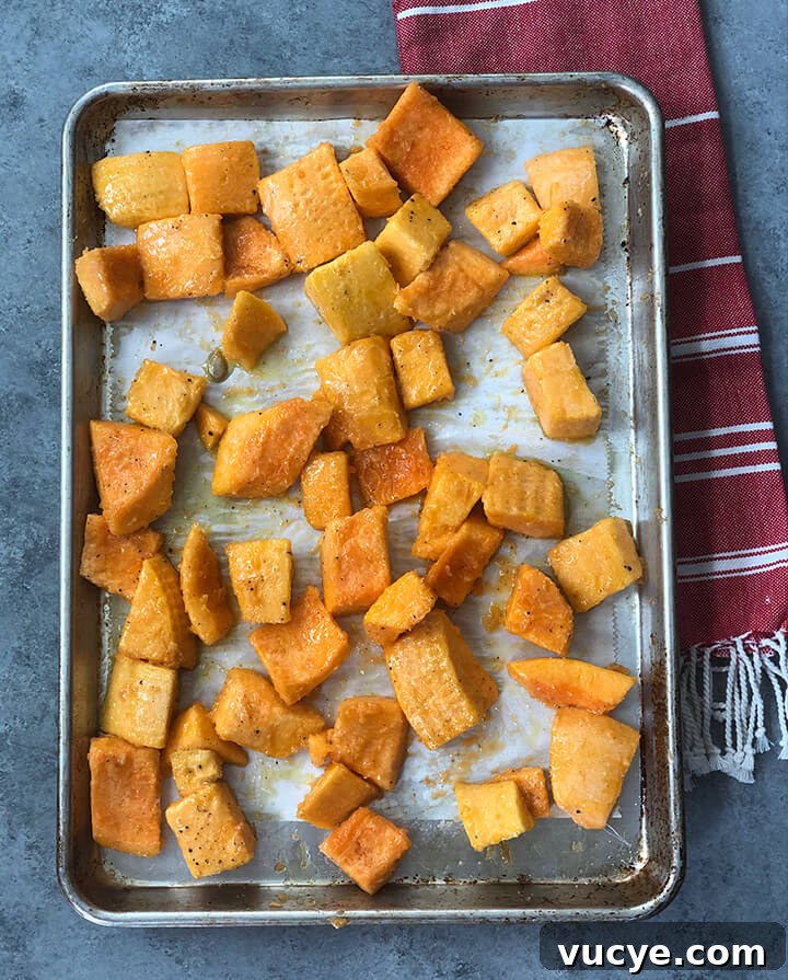 Squash on pan ready to roast for butternut squash soup.