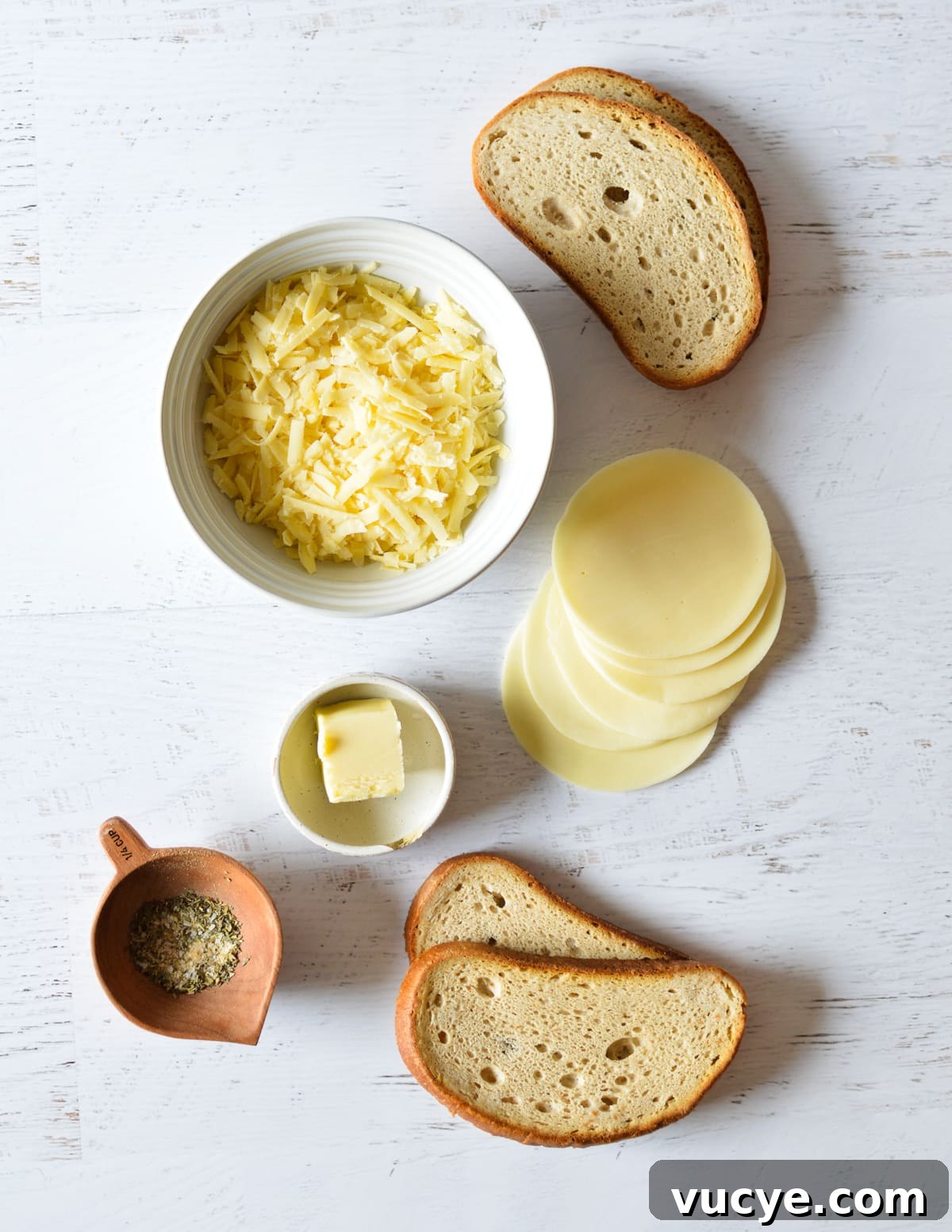 slices of bread, shredded gruyere, provolone slices, butter, and spices. 