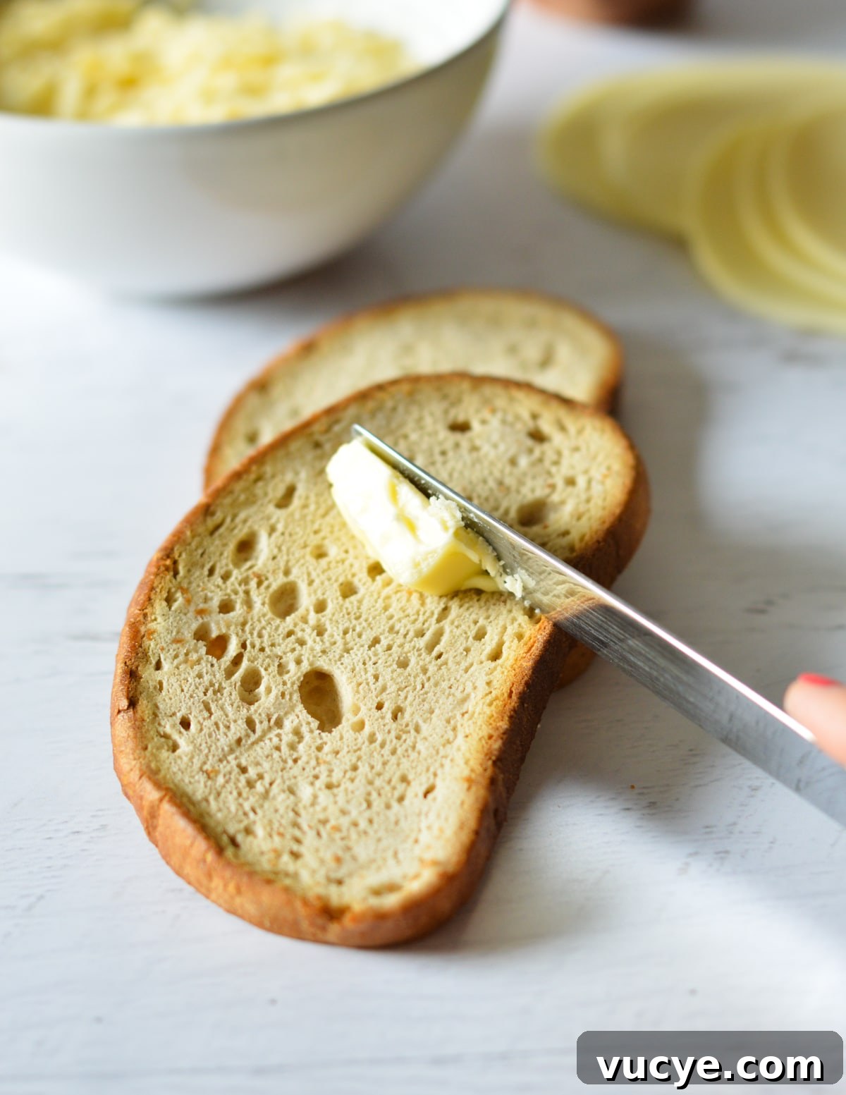 knife with butter on a slice of bread. 