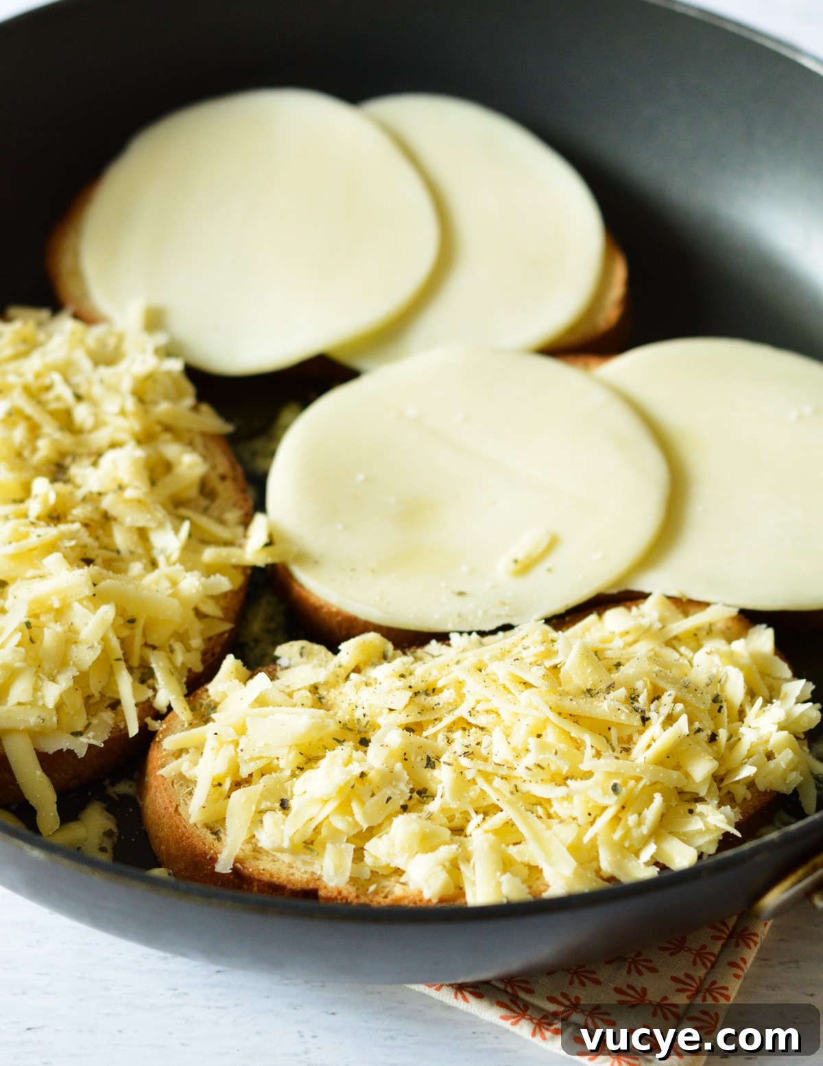 bread with cheese on it in a skillet. 