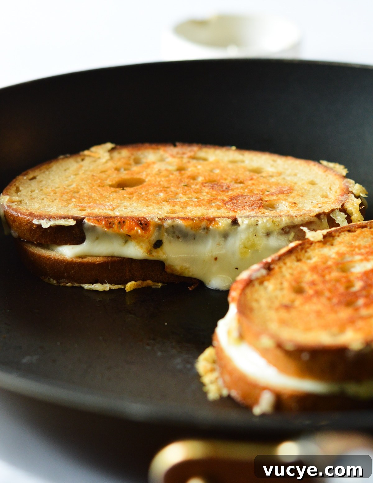 grilled cheese sandwich with melted cheese running down the side. 
