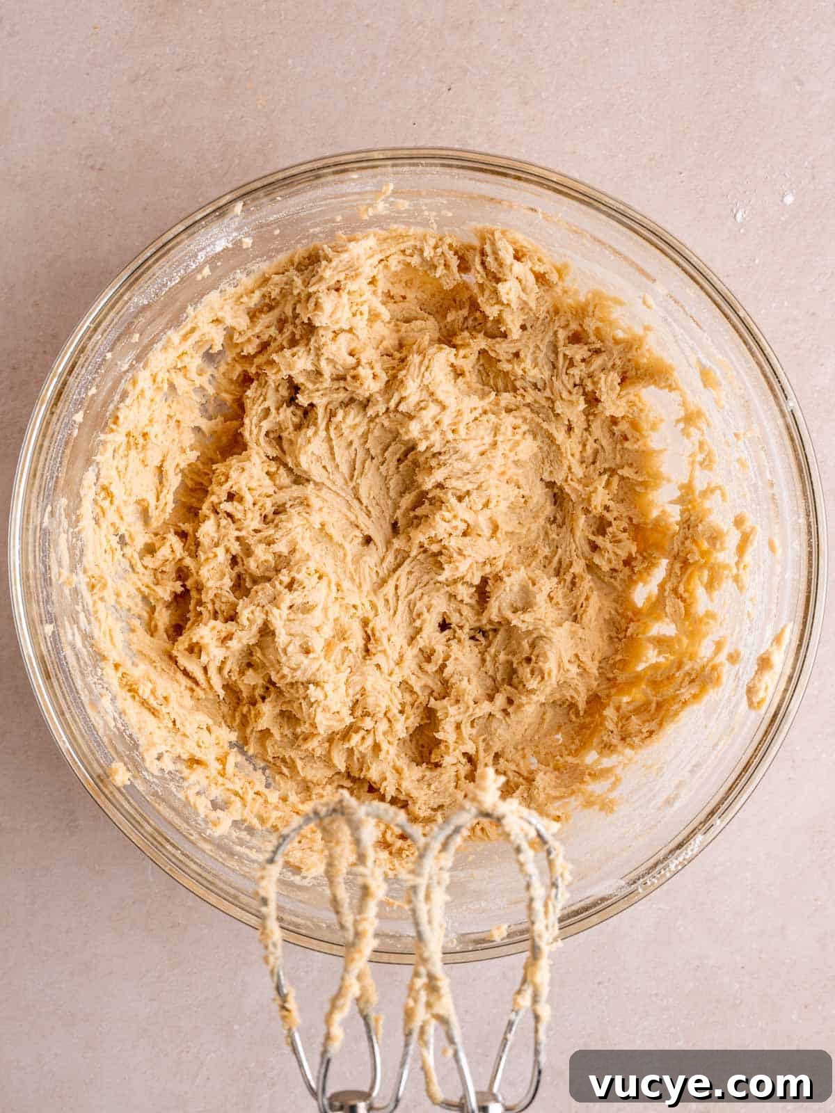 White Chocolate Macadamia Nut Cookies Recipe You’ll Love 5 Cookie dough mixed together in a bowl using a hand mixer.