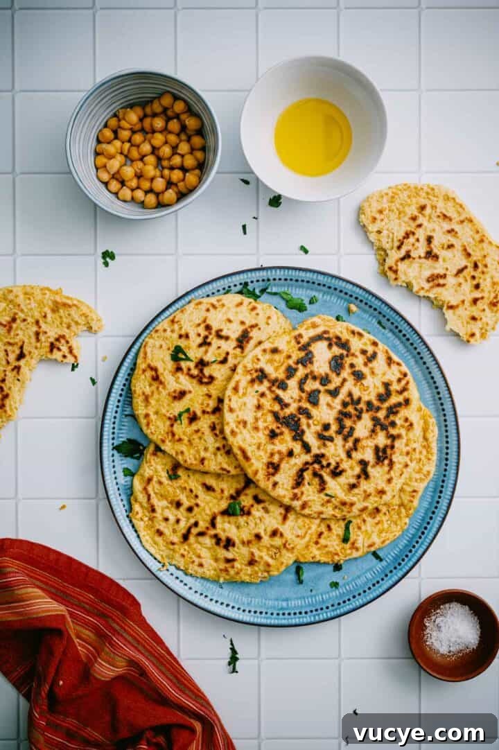 Chickpea flatbread served with olive oil and chickpeas.