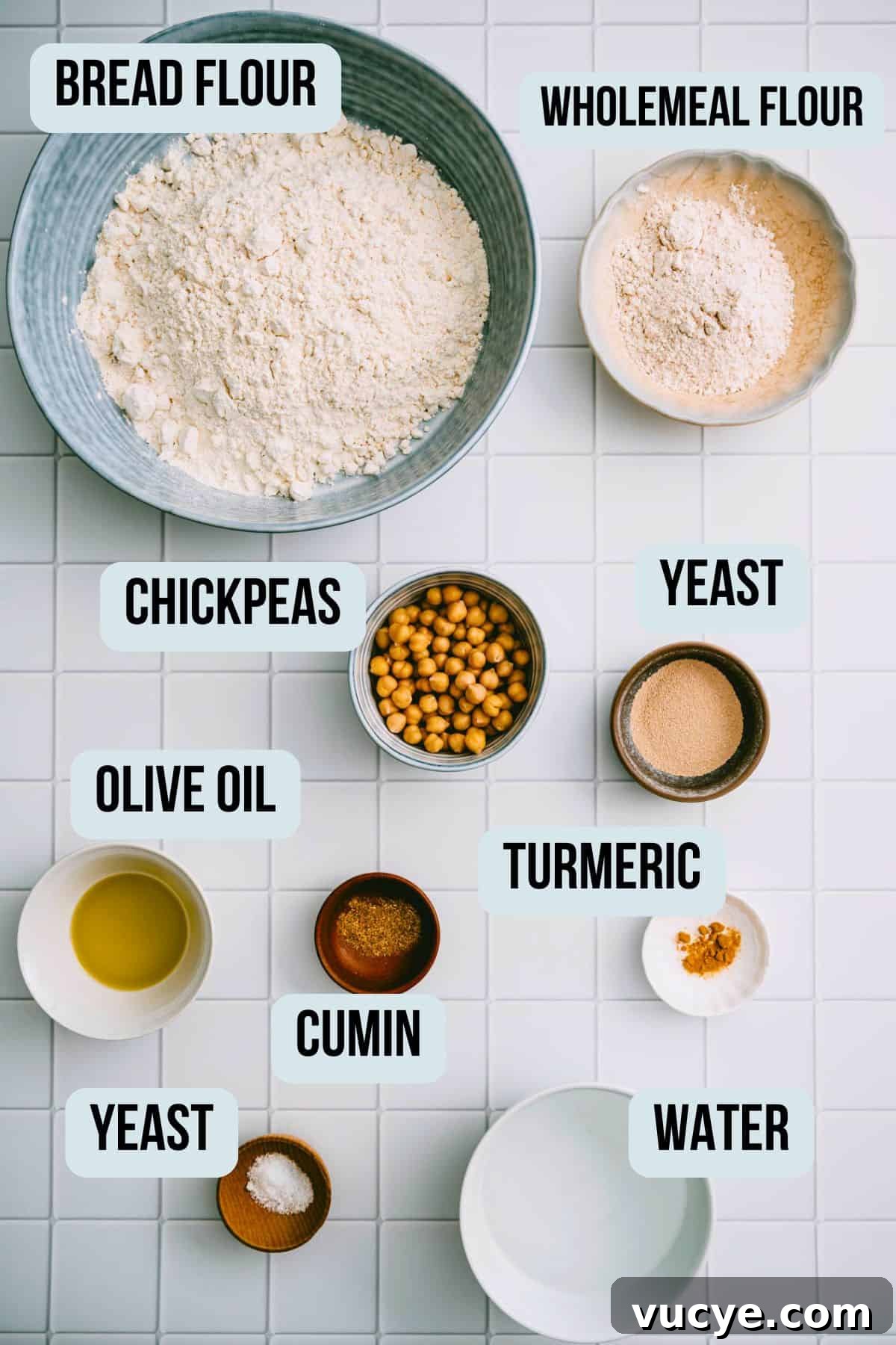 Ingredients needed to make chickpea flatbread on a tiled surface.