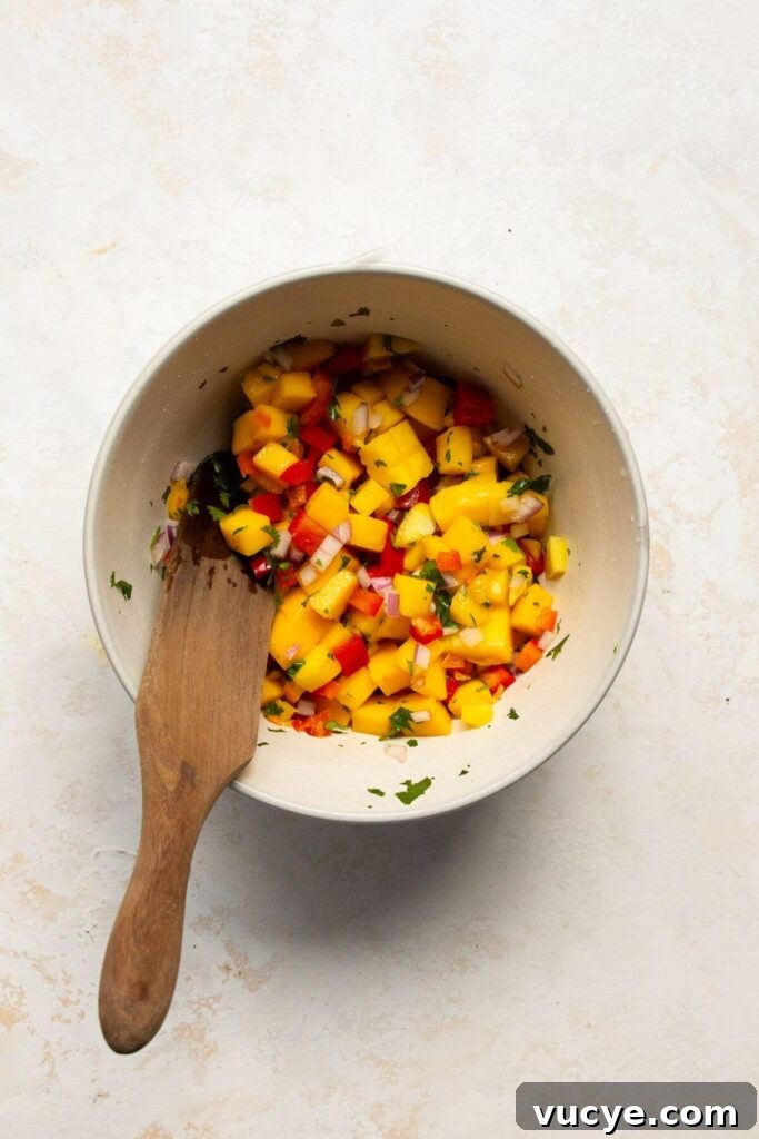 Mango Habanero Salsa Recipe: Fresh, Tangy, Spicy Mango Salsa 5 spicy mango habanero salsa in a mixing bowl after being combined