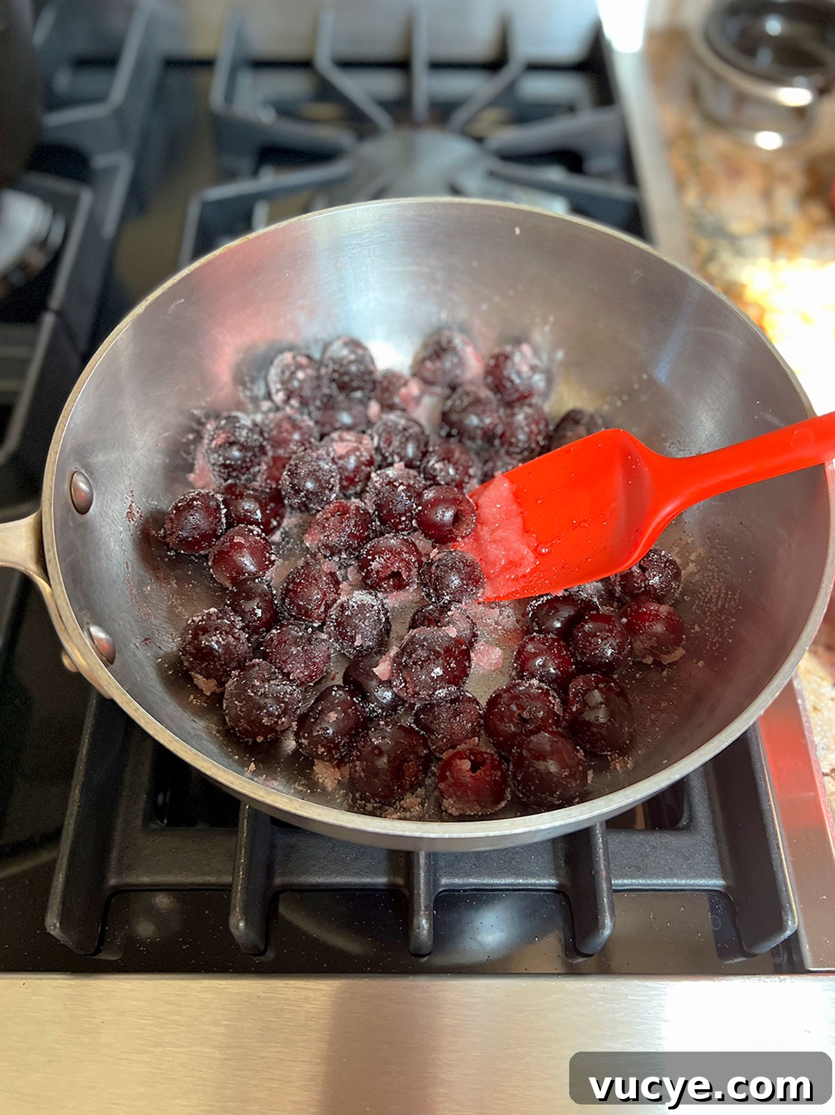 Mini Cherry Hand Pies: Bite-Sized Fruit Pastries Recipe 5 Cherries and sugar in pot starting to heat up.