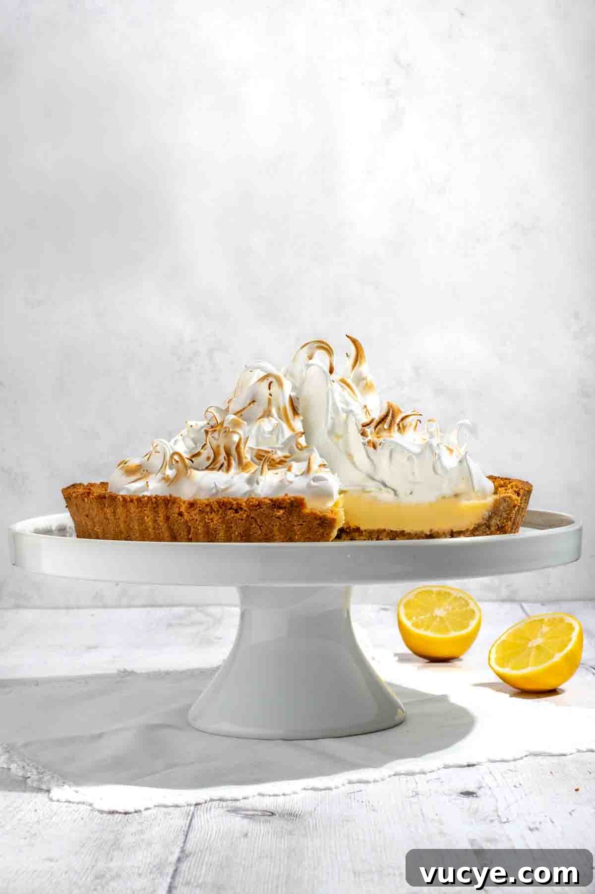 Lemon Meringue Pie with a Buttery Biscuit Crust Recipe 2 Biscuit base lemon meringue pie on a cake stand.