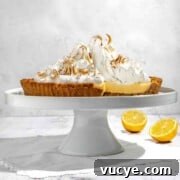 Lemon Meringue Pie with a Buttery Biscuit Crust Recipe 8 Biscuit base lemon meringue pie on a cake stand.