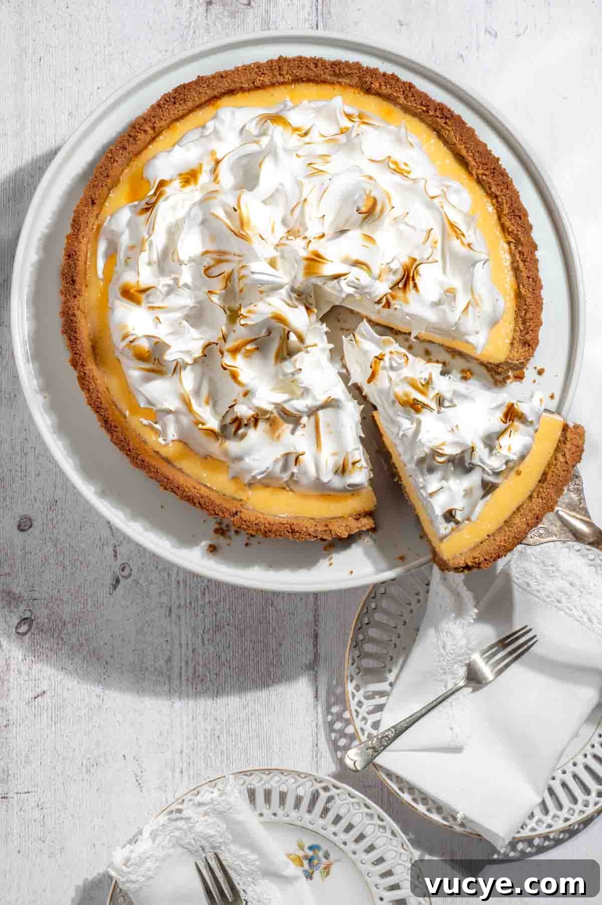 Lemon Meringue Pie with a Buttery Biscuit Crust Recipe 4 Biscuit base lemon meringue pie with one sliced piece.