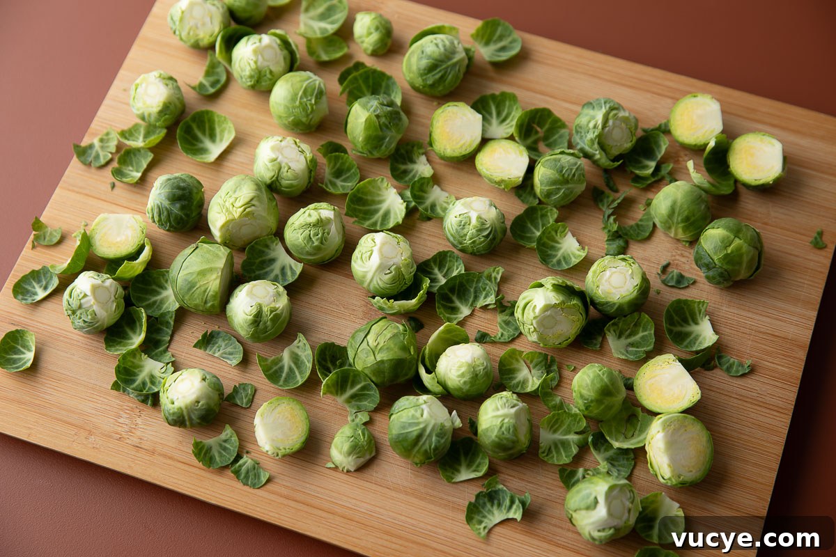 Apple Cranberry Brussels Sprout Salad with Maple Citrus Vinaigrette 5 fresh brussels sprouts trimmed on a cutting board