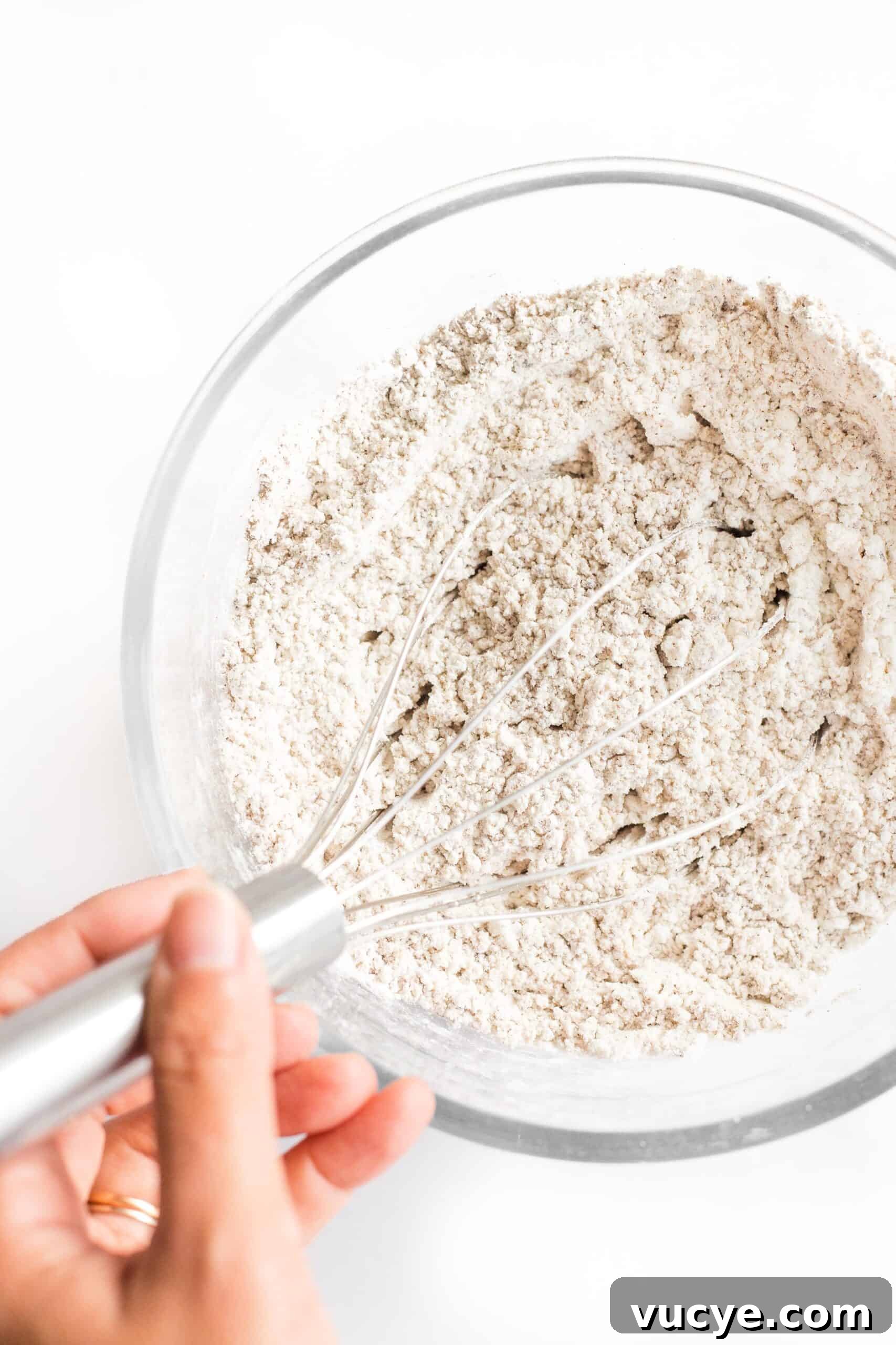 Easy Linseed Bread (Gluten-Free, Dairy-Free) Whisking dry ingredients in a bowl.