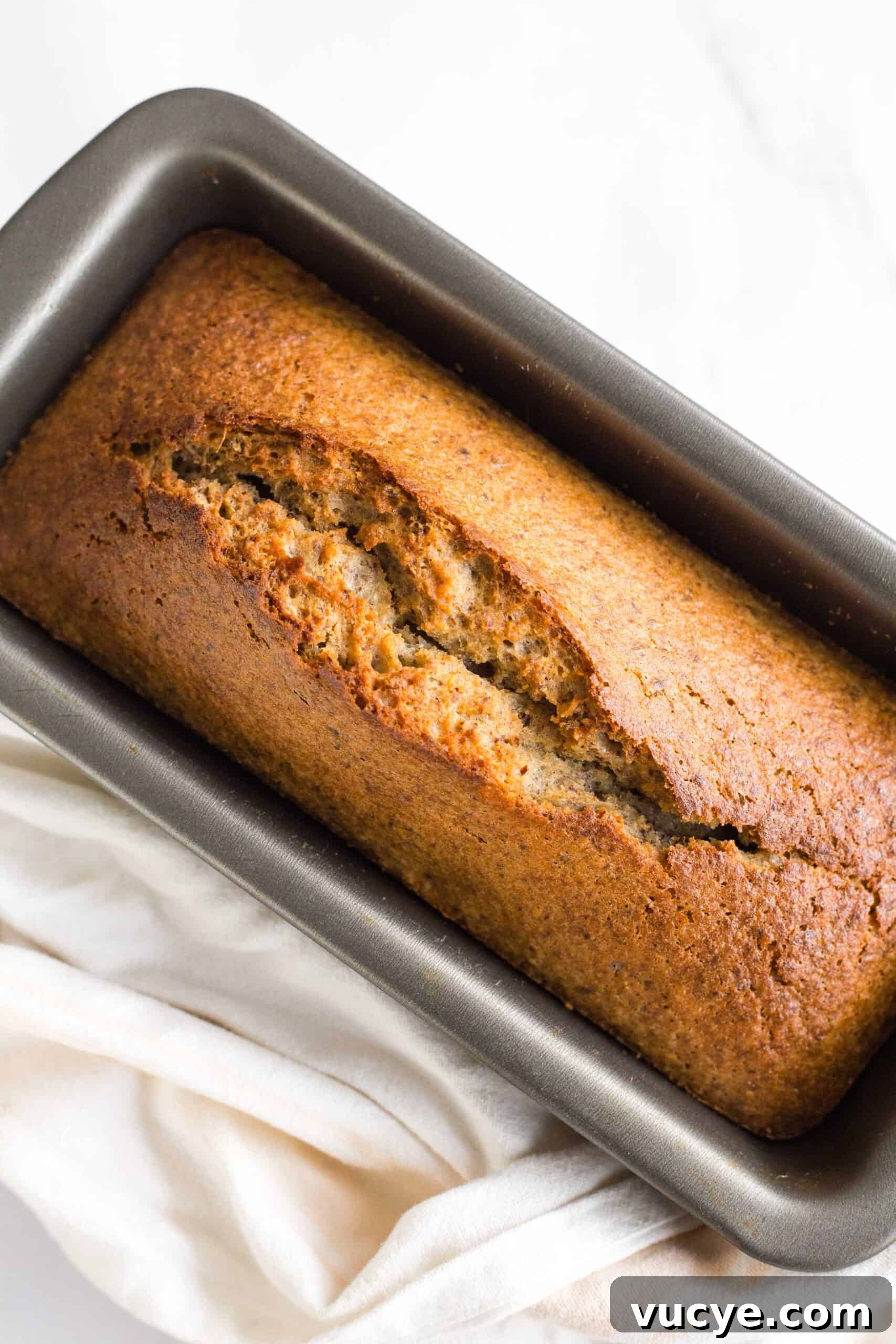 How to Make Flaxseed Bread (Gluten-Free, Dairy-Free) Freshly baked loaf of flax bread in metal loaf pan.