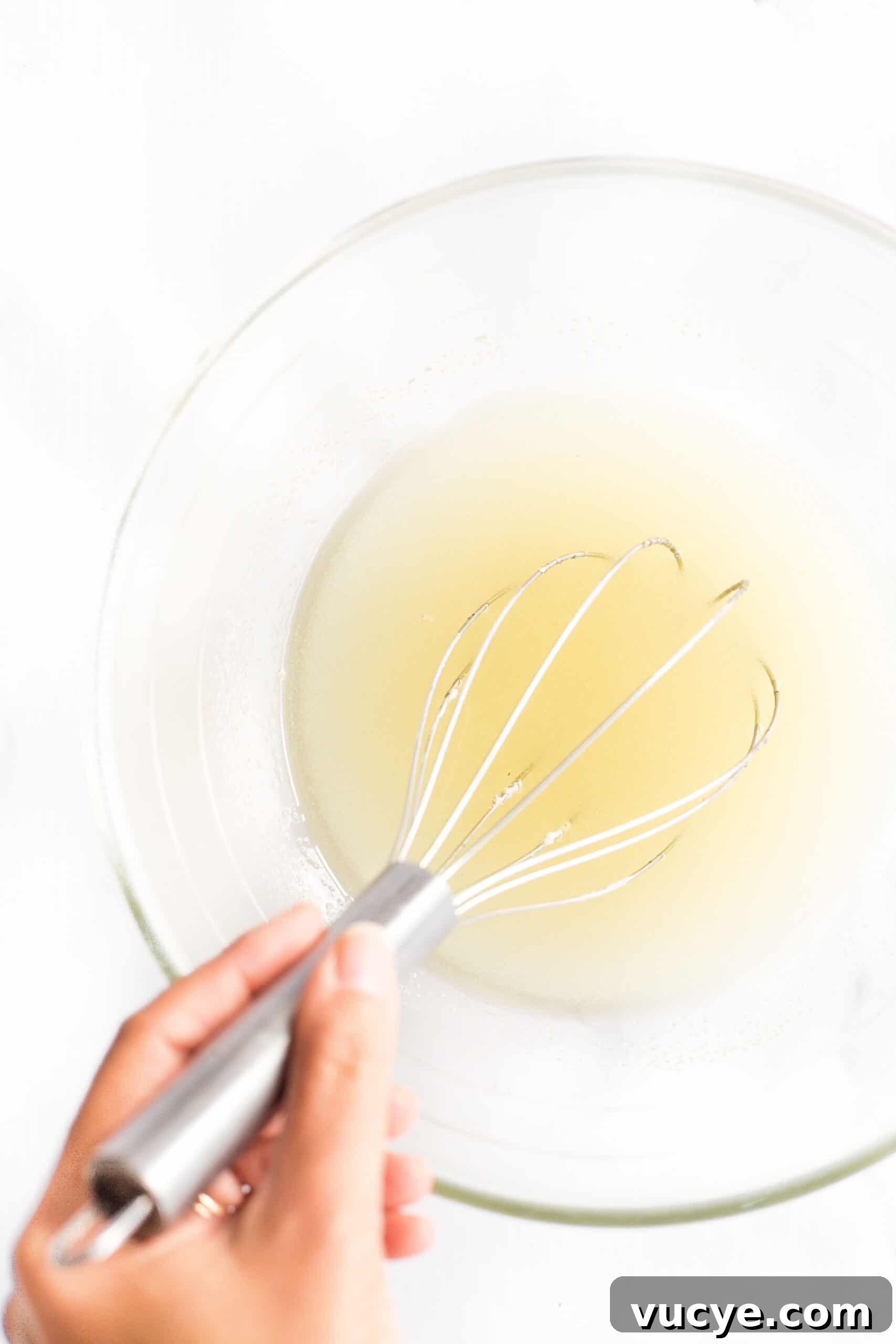 Easy Flaxseed Bread (Gluten-Free, Dairy-Free) Beating oil and sugar in a glass bowl.