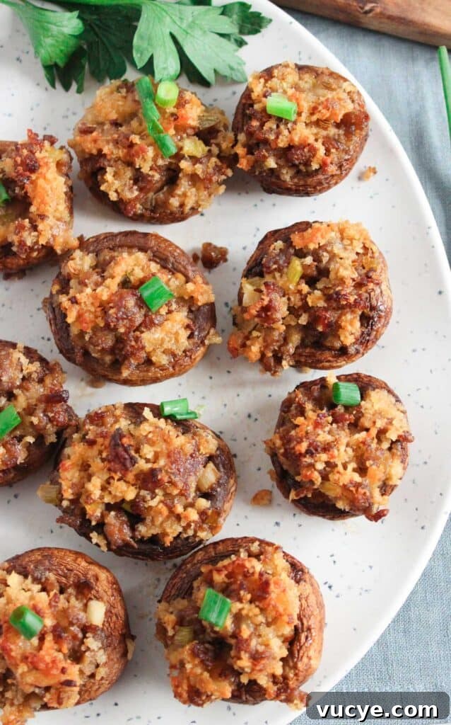 Italian-Style Stuffed Mushrooms with Garlic & Parmesan 2 Italian stuffed mushrooms on speckled plate