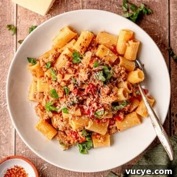 A plate of rigatoni with Italian sausage.
