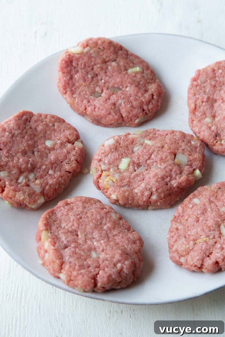 raw meat shaped into oval patties.