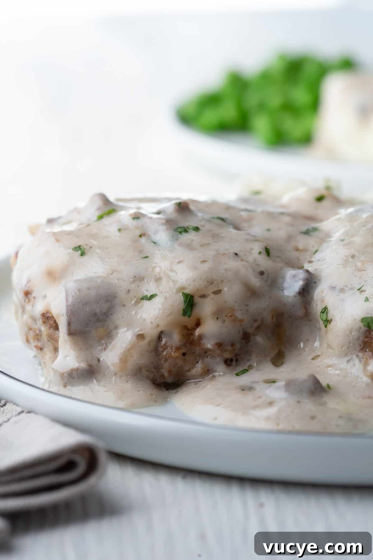 meat patty topped with cream of mushoom soup to create steak supreme.