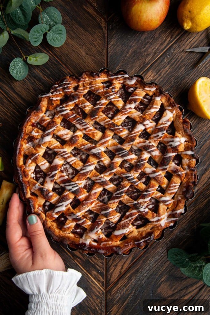 Bourbon-Drizzled Drunken Apple Pie Recipe 2 Drunken Apple Pie with Bourbon Glaze with hand cradling side of pie