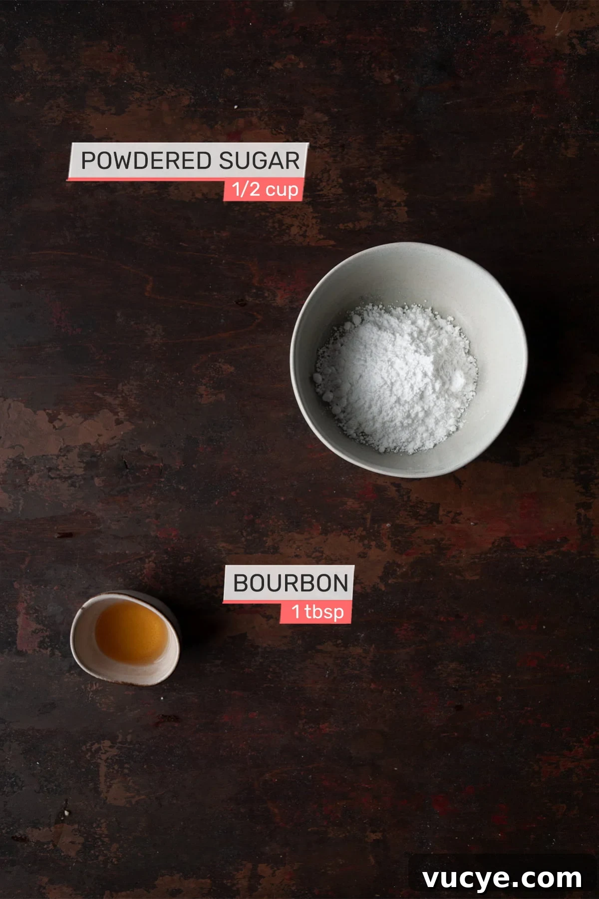 Bourbon-Drizzled Drunken Apple Pie Recipe 5 Overhead view of ingredients for bourbon drizzle on a brown wood background - powdered sugar, bourbon.