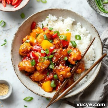 7-Day Budget Meal Plan for April 13–19: Affordable Weekly Menu 3 Easy sweet and sour chicken with peppers and pineapple on a white plate.