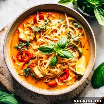 7-Day Budget Meal Plan for April 13–19: Affordable Weekly Menu 5 Red Curry Thai noodles with chicken and basil in a white bowl.