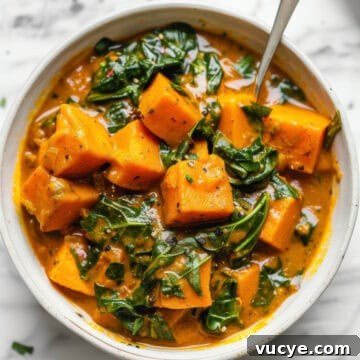 7-Day Budget Meal Plan for April 13–19: Affordable Weekly Menu 6 Sweet potato curry with spinach in a white bowl.