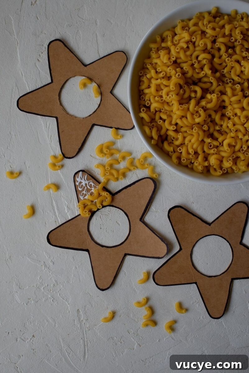 Handmade Pasta Christmas Ornaments: DIY Holiday Decorating Ideas 6 Cut out stars, with the middle cut out also, gluing macaroni noodles to them.