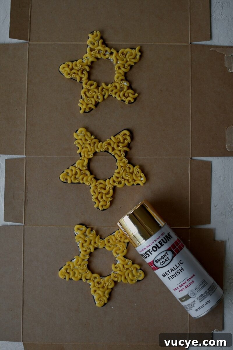 Handmade Pasta Christmas Ornaments: DIY Holiday Decorating Ideas 7 Macaroni pasta has all been glued on, before spray painting gold.