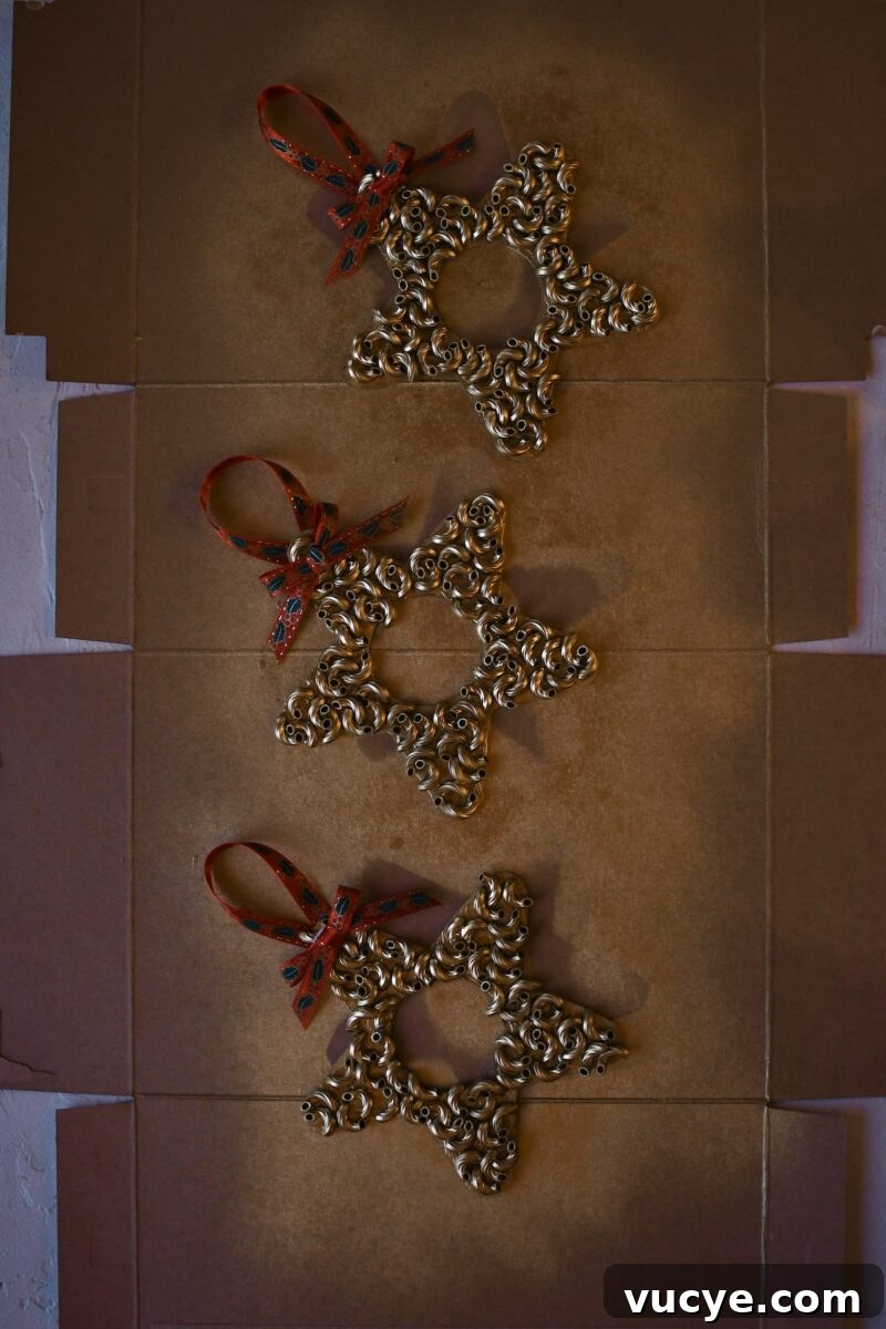 Handmade Pasta Christmas Ornaments: DIY Holiday Decorating Ideas 8 Macaroni pasta has all been glued on, after spray painting gold and adding a ribbon for hanging and a bow.