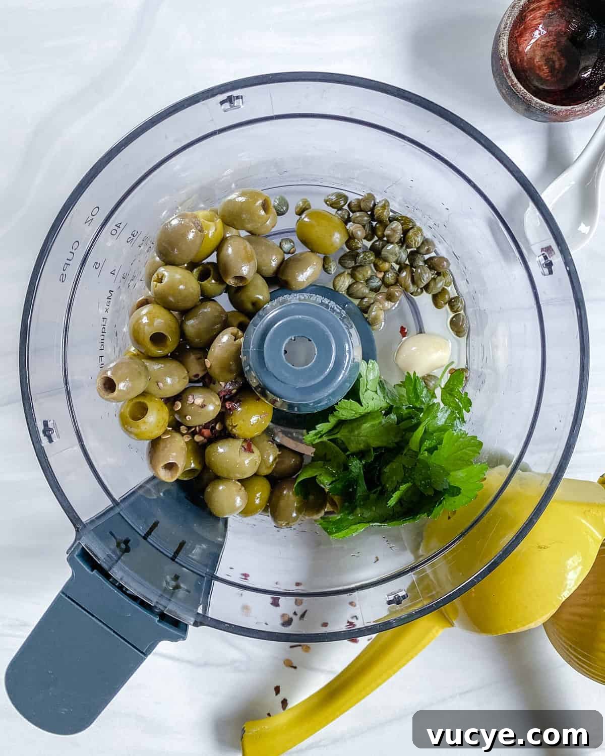 Process showing ingredients in a blender against white background.