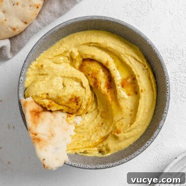 completed Curried White Bean Dip in a gray. bowl against a white background