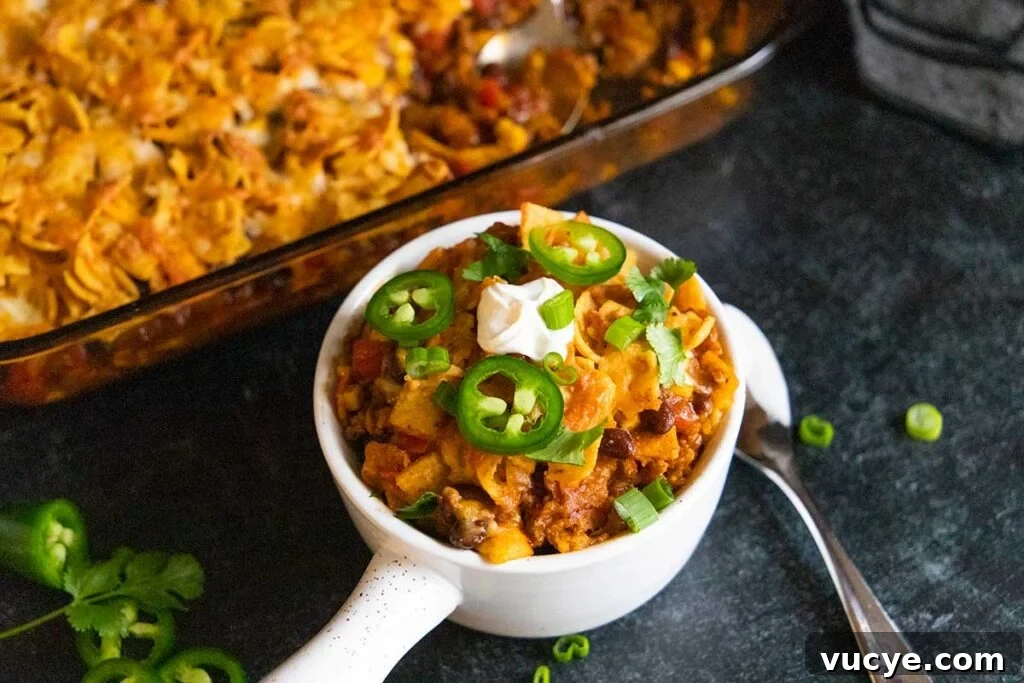 Cheesy Frito Pie Casserole with Chili and Corn Chips 2 Frito pie casserole in a white bowl.