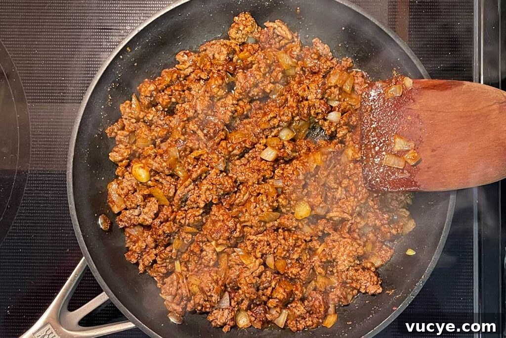 Cheesy Frito Pie Casserole with Chili and Corn Chips 4 Browned beef, onions, and mexican spices in a skillet