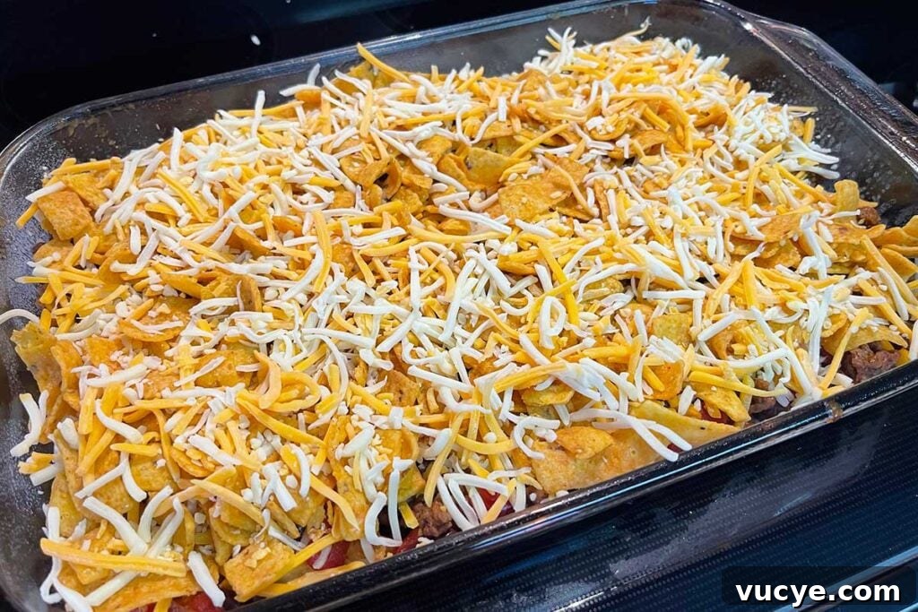 Cheesy Frito Pie Casserole with Chili and Corn Chips 6 Frito pie casserole assembled and ready for baking