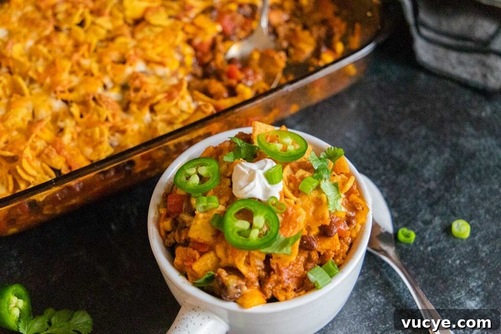 Cheesy Frito Pie Casserole with Chili and Corn Chips 8 Frito Pie Casserole in a white bowl