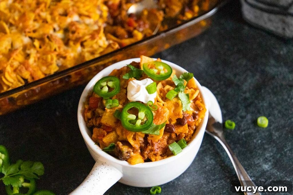 Cheesy Frito Pie Casserole with Chili and Corn Chips 10 Frito pie casserole in a white bowl