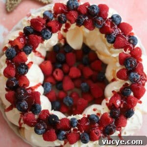 Panettone Bread and Butter Pudding Recipe — Festive Dessert Guide 13 An overhead shot of a meringue wreath with cream and berries.
