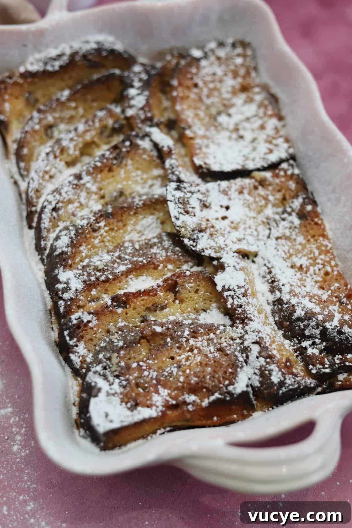 Panettone Bread and Butter Pudding Recipe — Festive Dessert Guide 7 Panettone bread and butter pudding in a pink serving dish.