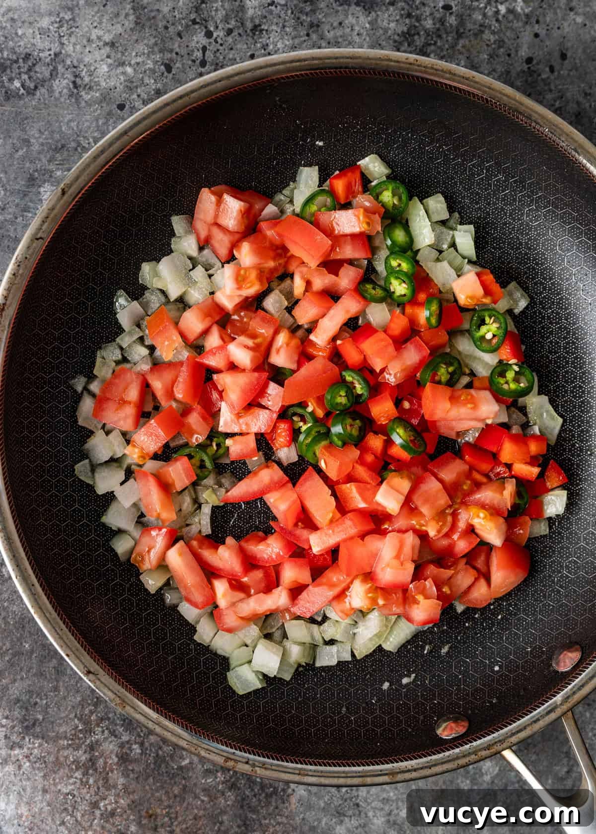 overhead process shot: chopped vegetables in a skillet before cooking