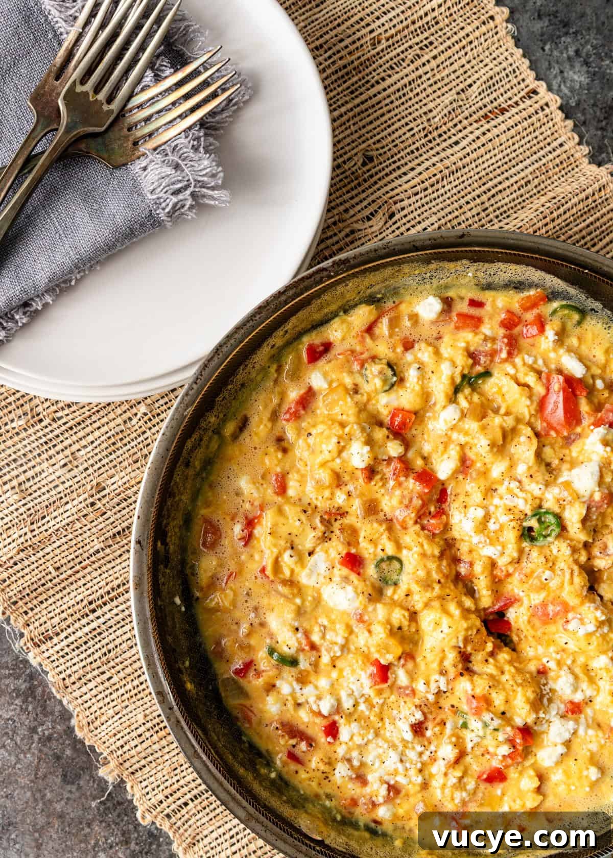 overhead: a skillet of menemen with tomatoes and feta