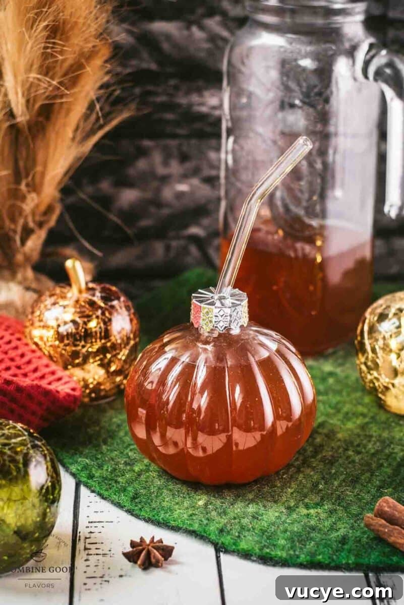 Spiced Apple Cider Recipe: Warm Homemade Mulled Cider 2 Homemade spiced apple cider in pumpkin shaped drinking glass.