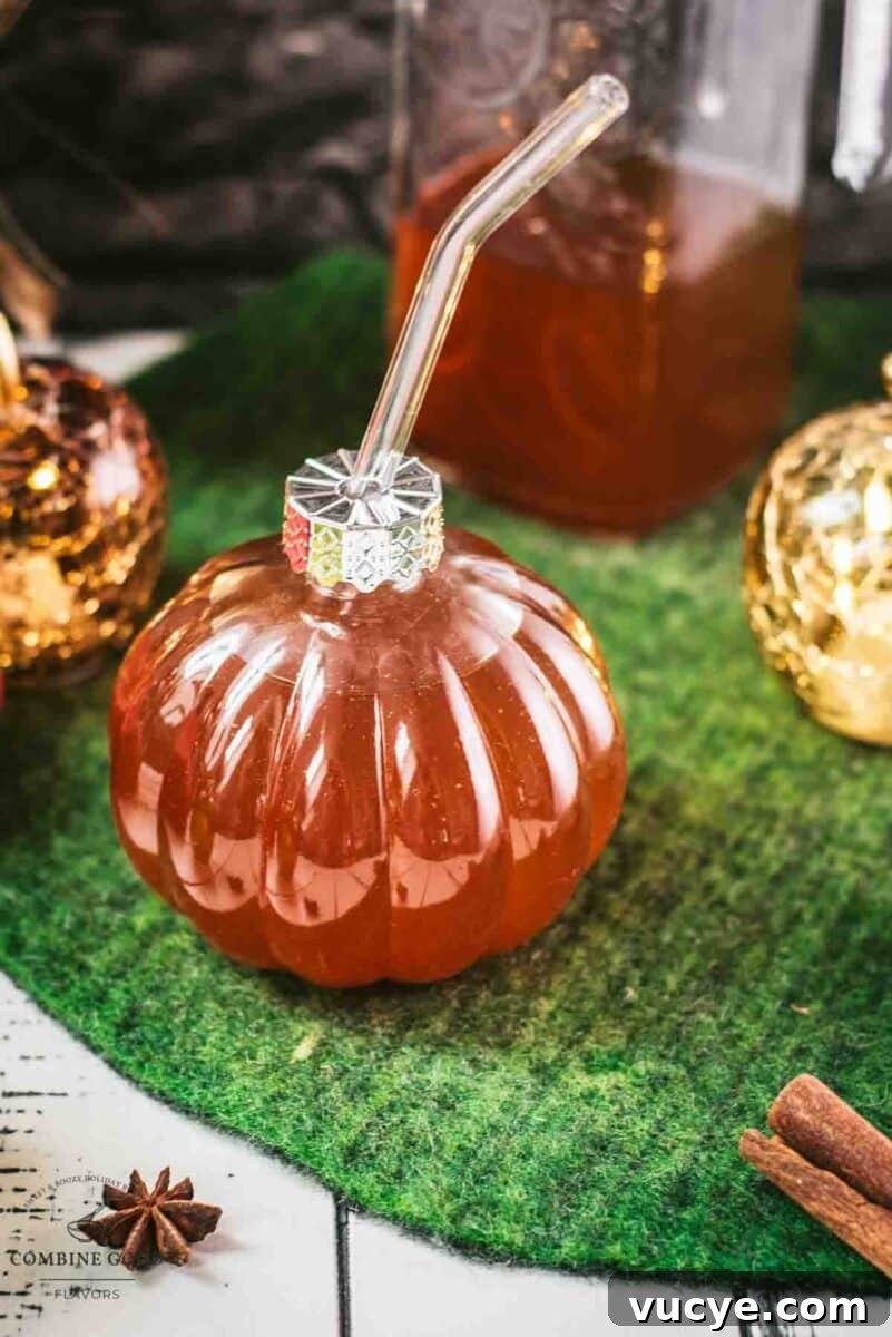 Spiced Apple Cider Recipe: Warm Homemade Mulled Cider 4 Homemade spiced apple cider in pumpkin shaped drinking glass.