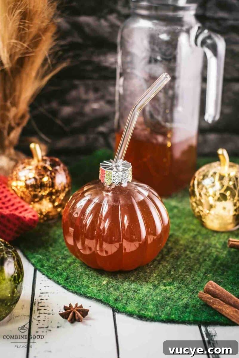Spiced Apple Cider Recipe: Warm Homemade Mulled Cider 5 Homemade spiced apple cider in pumpkin shaped drinking glass.